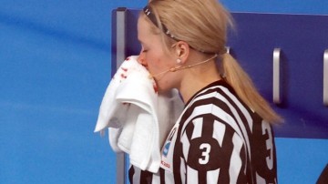 Referee Cianna Lieffers accidentally hit during the US and Canada ice hockey game at Winter Olympics